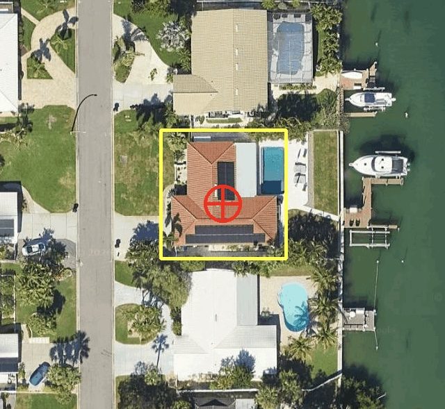 Aerial image of a waterfront property with solar on the roof
